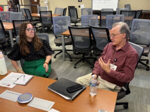 Paul Prather, Ph.D., (right) talks to Murphy Hernandez of Harding University about the addictive states caused by drug abuse.