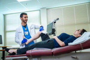 Physician checks flexibility of patients knee as she lies down