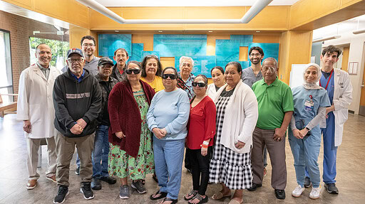 Jones Eye Institute doctors and Marshallese patients pose for a photo after the patients received cataract surgeries