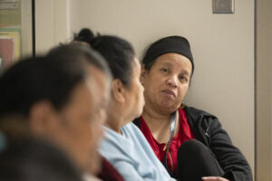 Mandy Ritok listens as she and other patients talk amongst themselves prior to surgery