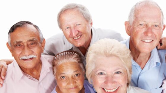 A group of five older adults — two women and three men — poses for a group photo in this stock image.