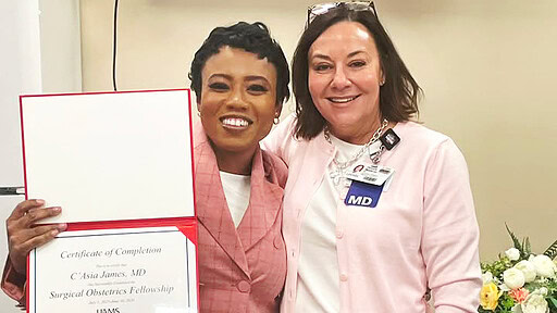 C'Asia James holds diploma with Donya Watson, M.D.