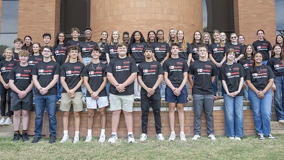 A group of high school students poses for a photo commemorating the College of Pharmacy's 2026 summer camp