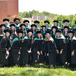 The UAMS Doctor of Physical Therapy class of 2026 poses in their regalia on the UAMS Northwest Campus lawn.