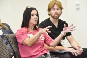 Ashley Harden gestures as she asks a question