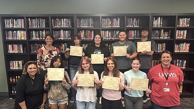 Students from Huntsville High School pose with their CHW training certificates