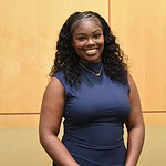 Malayah Lee stands in front of a wall in the Daniel W. Rahn Interprofessional Education Building at UAMS.