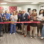 Rohit Dhall, M.D., prepares to cut the ribbon officially opening the UAMS Health Neurology Clinic in the Doctors Building as Jonathan Goree, M.D., (left of Dhall, front row), and Scott Lucchese (right of Dhall, front row), Michelle Krause, M.D., and Ron Robertson, M.D., look on.