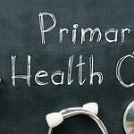 Primary Health Care written on chalkboard with stethescope