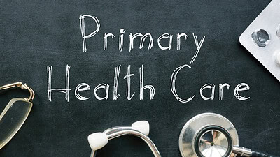 Primary Health Care written on chalkboard with stethescope