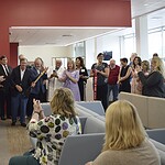 UAMS Chancellor C. Lowry Barnes, M.D., (center) smiles as onlookers clap after he cuts the ribbon to formally open the newest and largest UAMS Health Orthopaedic & Sports Medicine Clinic.