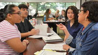 Student acts surprised at something Ana Sanchez is teaching them.