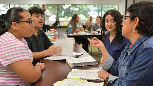 Student acts surprised at something Ana Sanchez is teaching them.