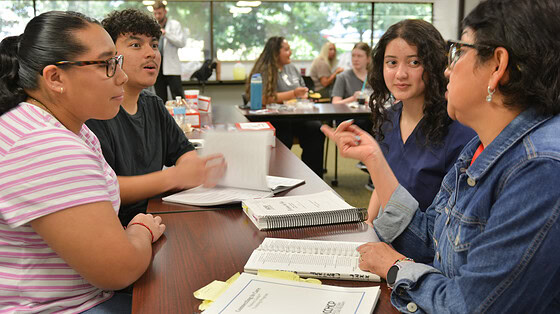 Student acts surprised at something Ana Sanchez is teaching them.