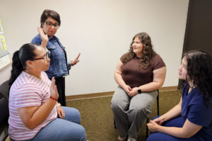 Ana Sanchez shows a student how to interrupt
