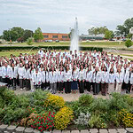 Group photo in front of UAMS fountain of UAMS College of Medicine Class of 2026 in white coats