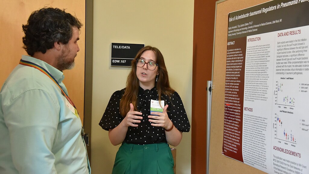 <p>Harding University’s Murphy Hernandez discusses her work with Ryan Allen, Ph.D., at the Arkansas Undergraduate Summer Research Symposium.</p>
<div><a class="more" href="https://news.uams.edu/2026/08/07/uams-summer-undergraduate-symposium-features-student-research/hernandez-feature/">Read more</a></div>