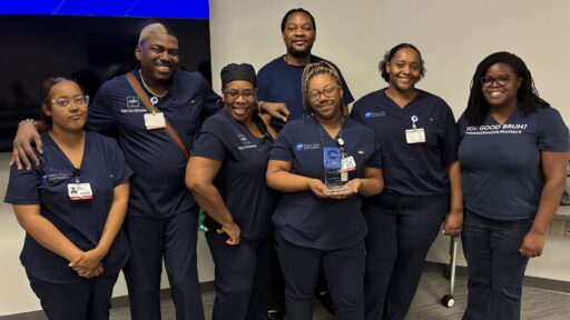 Members of the University of Arkansas for Medical Sciences (UAMS) medline group pose after being presented with the Barbershop Talk Wellness Challenge trophy. They earned the award due to finishing at the top of the team rankings. Camille Hart, MPH, (far right) Barbershop Talk research program director is shown alongside the team.