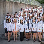 Students and faculty of the Department of Audiology and Speech Pathology gather on the steps outside the I. Dodd Wilson Building after the white coat ceremony for the Doctor of Audiology Class of 2030 and the Master of Science in Speech-Language Pathology Class of 2028.