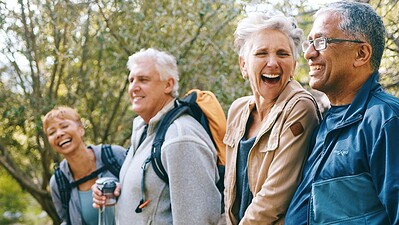 Older adults talking and laughing in a park.