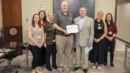Nathan Johnson, center, holds his Patriotic Employer Award certificate. Congratulating him are left to right, Sarah Parker, Cherika Robertson, Rebecca Bird, (Johnson), retired Col. Tom Anderson, Corinne Hollingsworth and Thao Vu. Except for Anderson, all are faculty members of the Department of Laboratory Sciences.