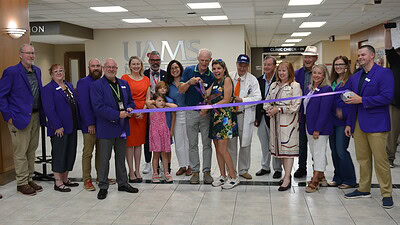 Scott and Jo Rampy cut the ribbon for the new UAMS Health MS Clinic in Fayetteville.