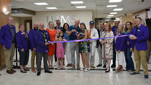 Scott and Jo Rampy cut the ribbon for the new UAMS Health MS Clinic in Fayetteville.