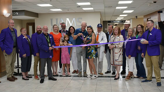 Scott and Jo Rampy cut the ribbon for the new UAMS Health MS Clinic in Fayetteville.