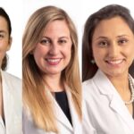 All four women are wearing white lab coats. Nahed O. ElHassan, Megha Sharma, and Ankita Shukla have dark hair, and Jennifer Rumpel has light hair.