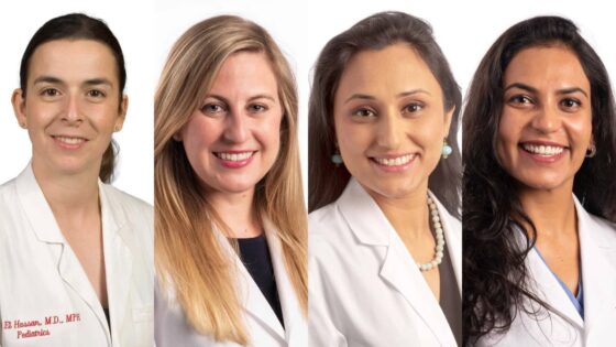 All four women are wearing white lab coats. Nahed O. ElHassan, Megha Sharma, and Ankita Shukla have dark hair, and Jennifer Rumpel has light hair.