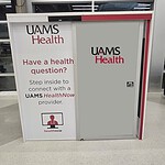 Front view of the UAMS Health telehealth booth at XNA airport.