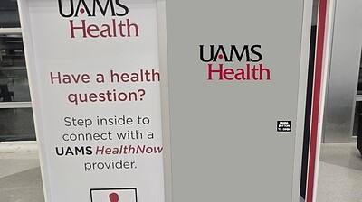 Front view of the UAMS Health telehealth booth at XNA airport.