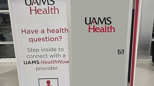 Front view of the UAMS Health telehealth booth at XNA airport.