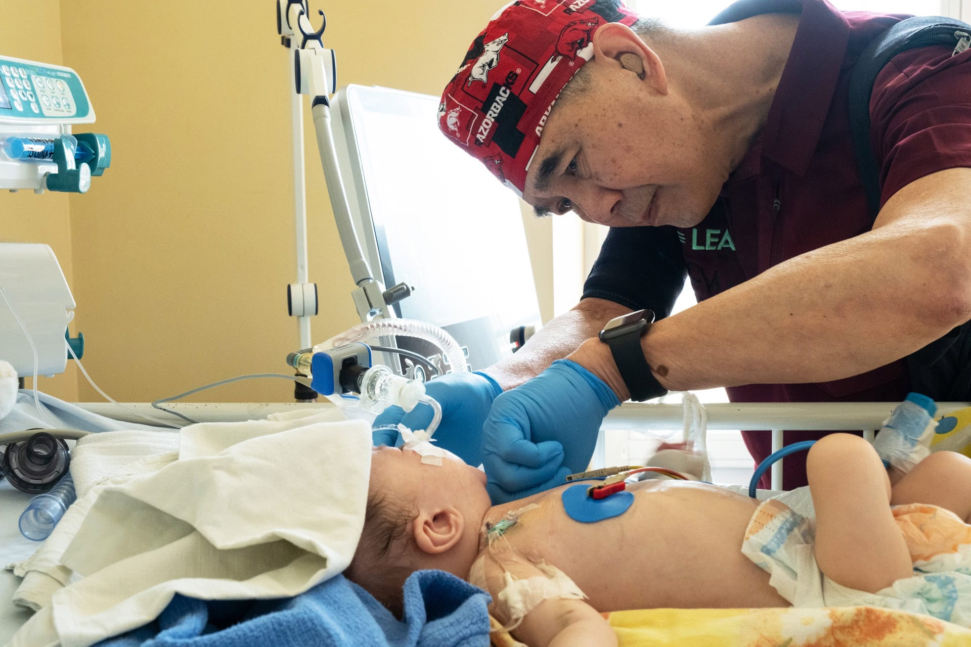 Suen examines a baby in a Ukrainian hospital.