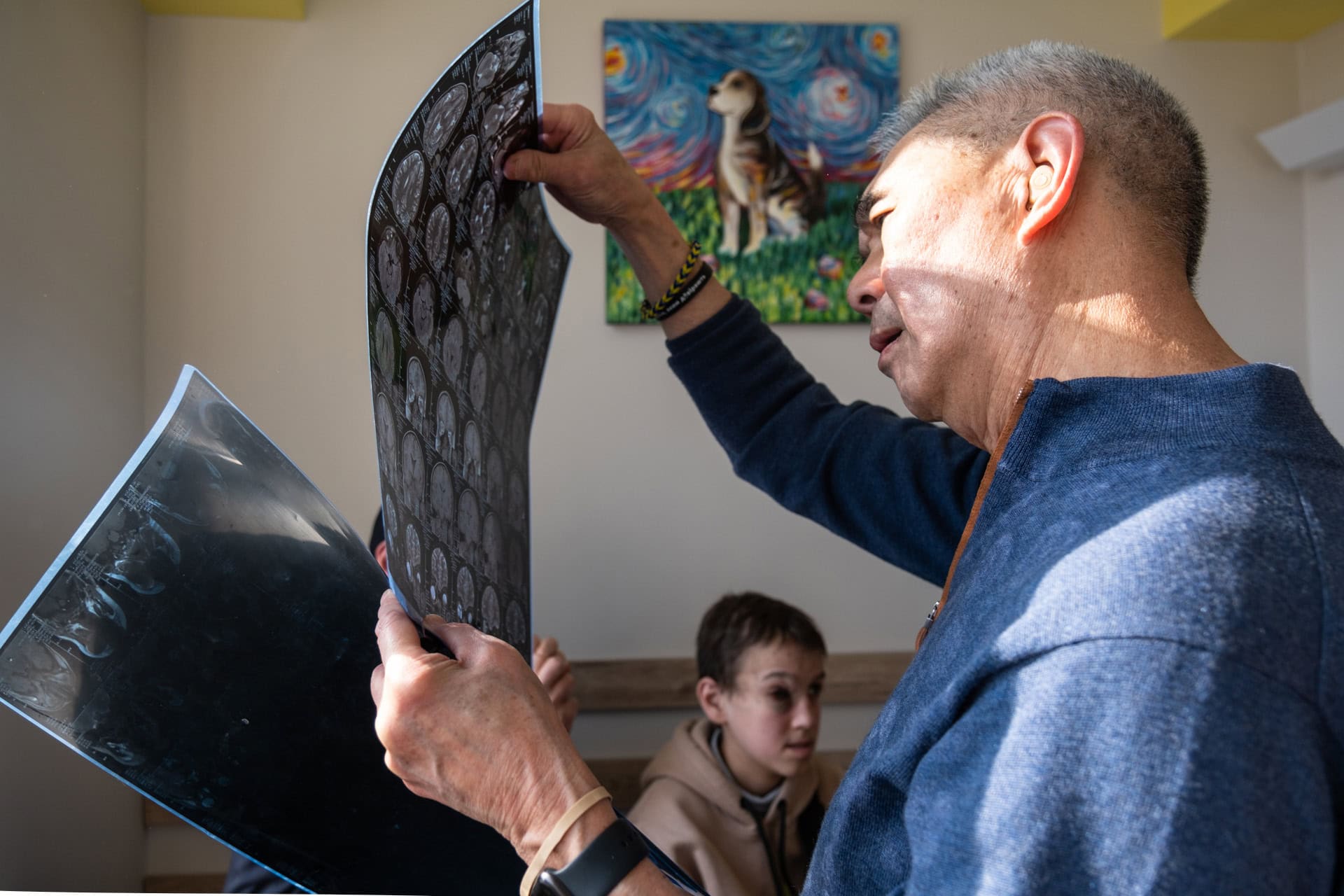 Suen examines some radiological images during a consultation with a patient.