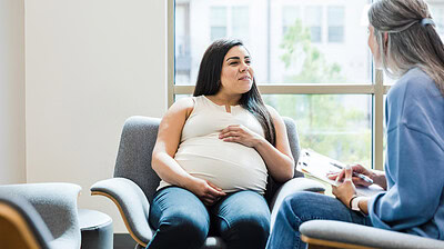 Doula speaking with a pregnant woman.