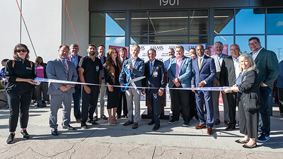Harrison Reed and Chancellor C. Lowry Barnes, M.D., cut the ribbon to officially open UAMS Health's new hospital in Bryant.