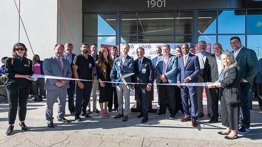 Harrison Reed and Chancellor C. Lowry Barnes, M.D., cut the ribbon to officially open UAMS Health's new hospital in Bryant.
