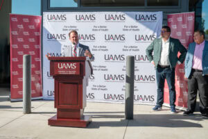 Saline County Judge Matt Brumley speaks while Bryant Mayor Chris Treat and Benton Mayor Tom Farmer look on.