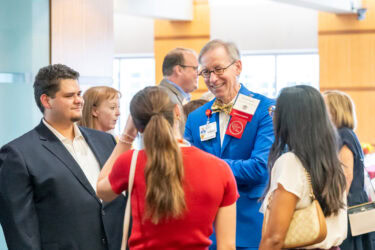 Michael Manley, assistant dean of community engagement and faculty practice in the College of Nursing, chats with a group of students at the reception.