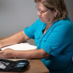 Woman using a remote glucose monitor