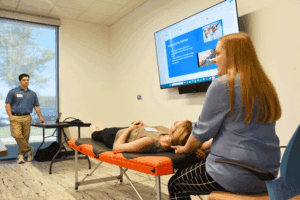 Kelsey Vinson, D.O., shows osteopathic manipulative medicine on a medical student.