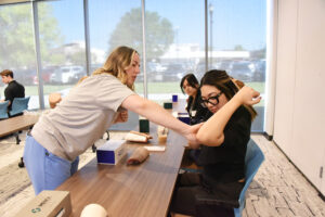 Oliva Ostermann, D.O., shows a medical student where to insert Nexplanon, a long-acting reversible contraception device.