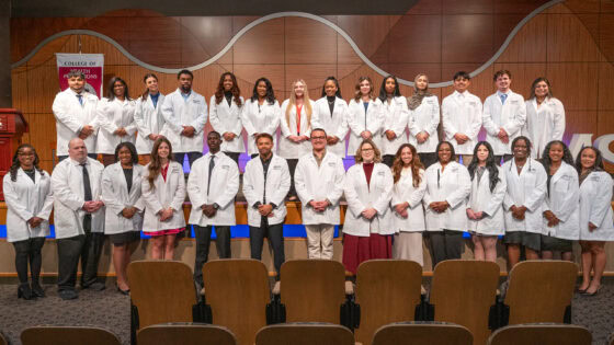 After the white coat ceremony, Respiratory Care students gather for group photo in Smith Auditorium. It was the first white coat ceremony for the program's students.