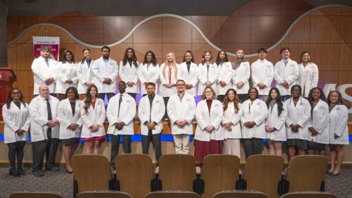 After the white coat ceremony, Respiratory Care students gather for group photo in Smith Auditorium. It was the first white coat ceremony for the program's students.