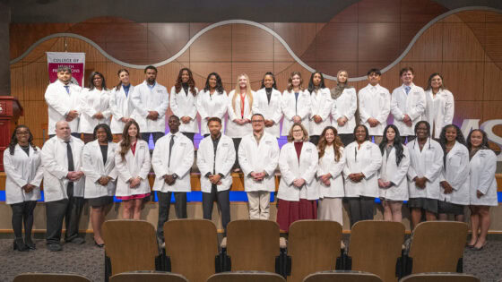 After the white coat ceremony, Respiratory Care students gather for group photo in Smith Auditorium. It was the first white coat ceremony for the program's students.