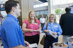 Sawyer Sparks, D.O., with UAMS Northeast Regional Campus talks wtih Gracen Hambrick and Emma Rouse, fourth-year medical students at UAMS.