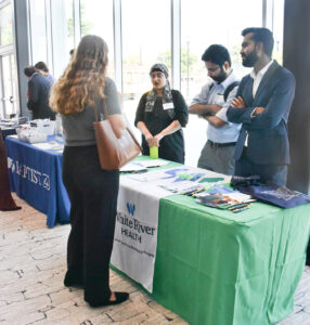 Students talk with White River Health residency booth.